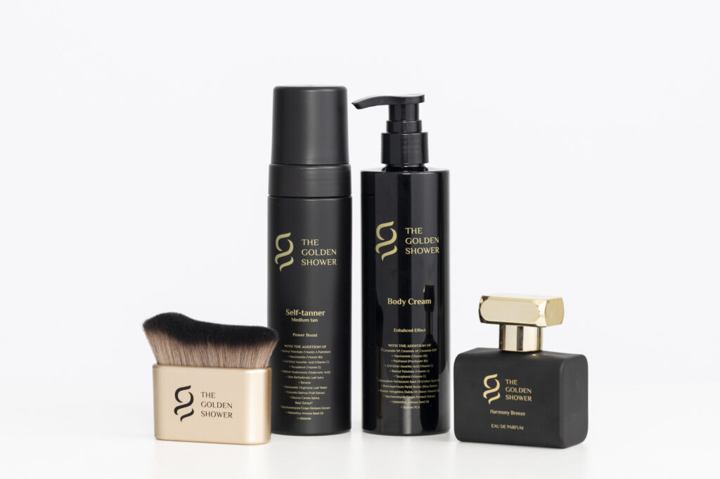 Complete four-piece beauty kit featuring tanning, skincare, and fragrance products